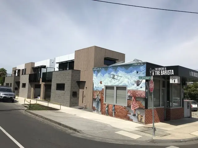 A mural on the corner of a shop building.