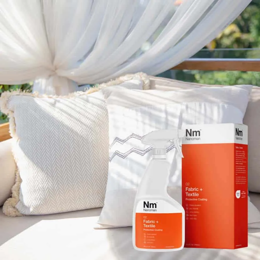 Fabric Waterproofing Spray on a daybed with white cushions