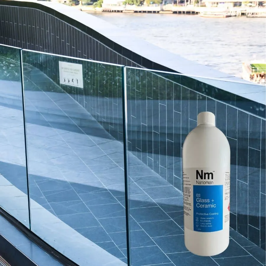 Glass coating 1 L beside a glass pool fence