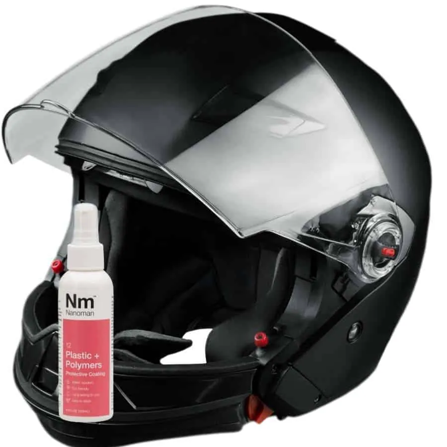Plastics Coating 125 ml beside a motorcycle helmet with a clear visor