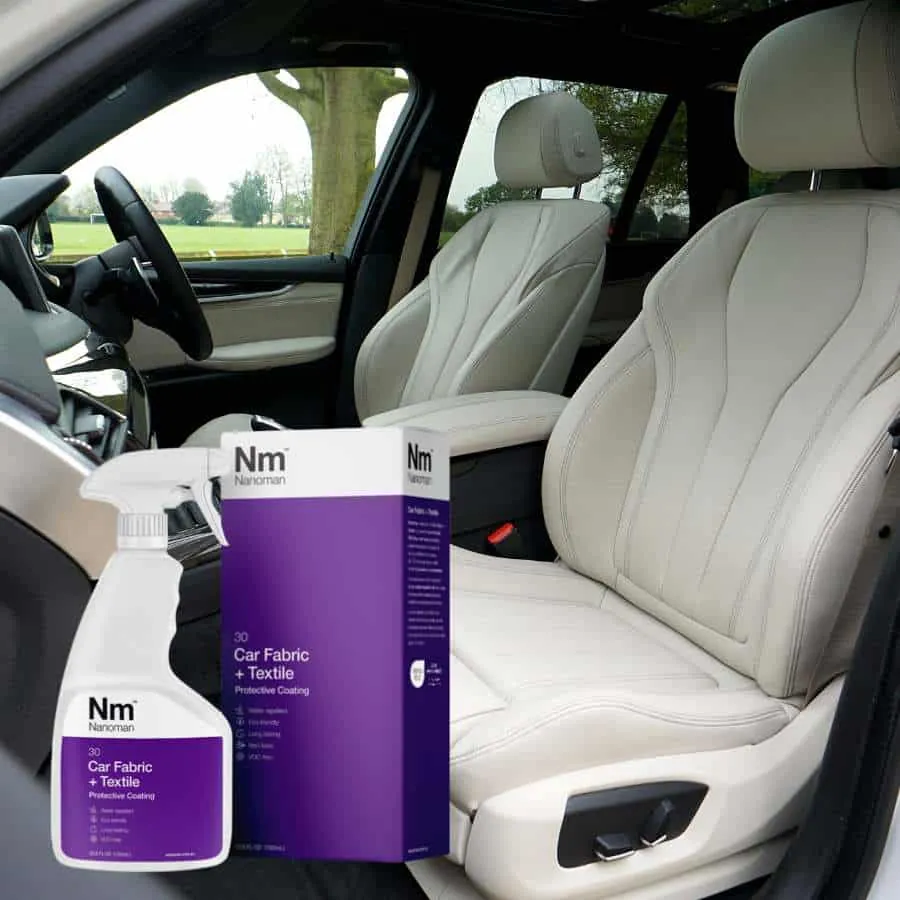 Car Fabric Protector Spray 750 ml and box beside the front seat of a car