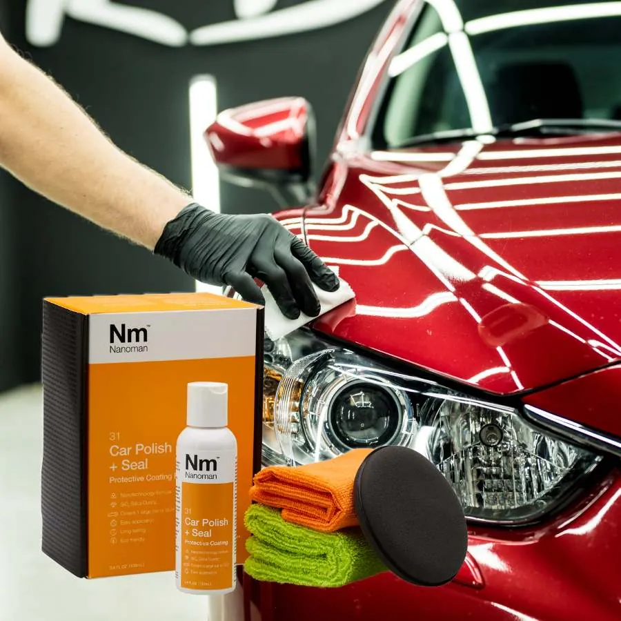 Car Polish and Sealant Kit beside a red car being polished by hand